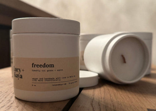 Jar labeled 'freedom' on a wooden surface with a blurred background